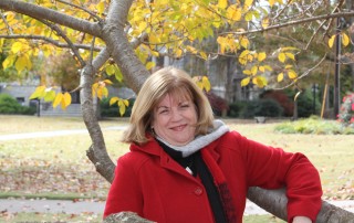 Debra posing in a tree